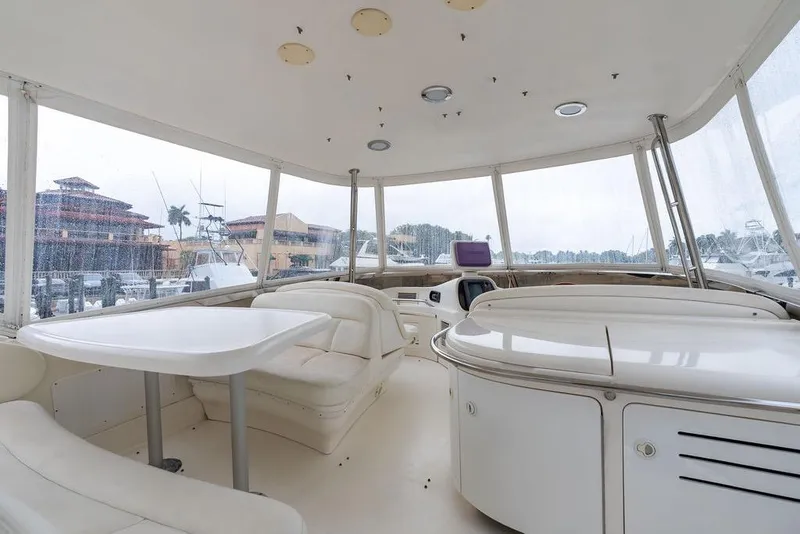 Slide: The Image of Interior view of 2000 Sea Ray 560 Sedan Bridge yacht with seating and table. - 29