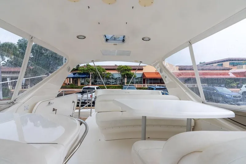 Slide: The Image of Luxurious interior of 2000 Sea Ray 560 Sedan Bridge yacht with spacious seating and table. - 30