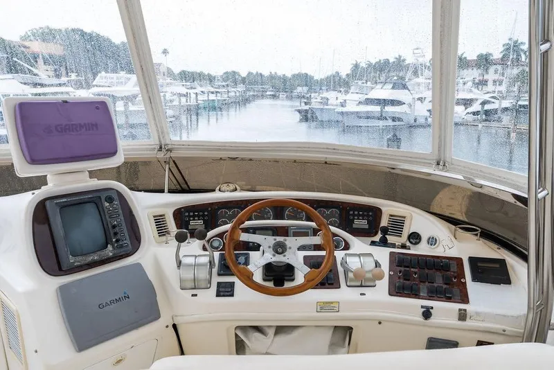Slide: The Image of Cockpit of 2000 Sea Ray 560 Sedan Bridge with Garmin navigation system, overlooking marina. - 35
