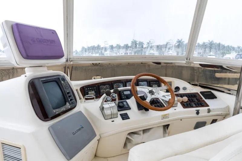 Slide: The Image of Cockpit of 2000 Sea Ray 560 Sedan Bridge with Garmin navigation system and wooden steering wheel. - 36