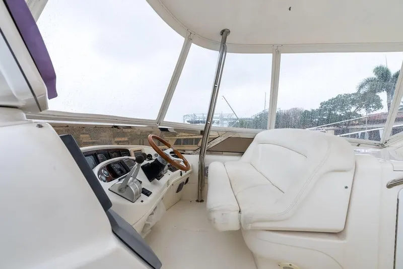Slide: The Image of Interior view of 2000 Sea Ray 560 Sedan Bridge yacht cockpit with steering wheel. - 38