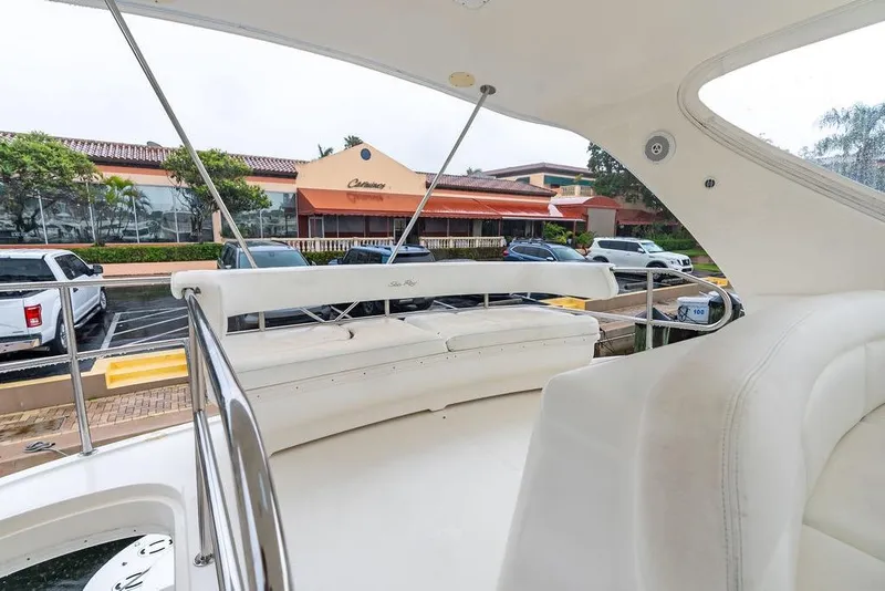 Slide: The Image of 2000 Sea Ray 560 Sedan Bridge yacht interior with white seating and marina view. - 39