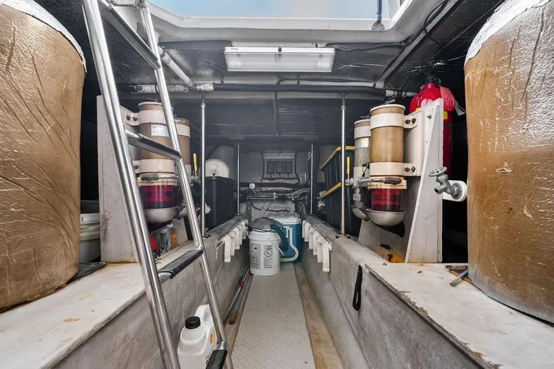 Slide: The Image of Engine room of a 2000 Sea Ray 560 Sedan Bridge yacht, featuring equipment and storage. - 44