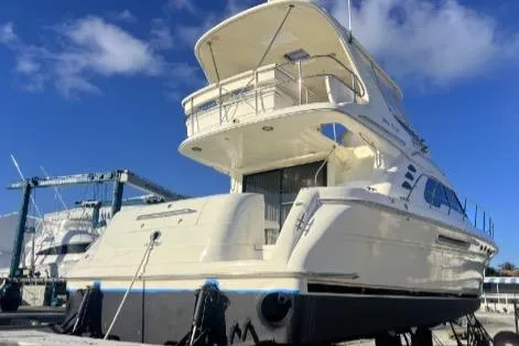Slide: The Image of 2000 Sea Ray 560 Sedan Bridge yacht docked under clear blue sky. - 50