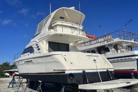 Slide: The Image of 2000 Sea Ray 560 Sedan Bridge yacht on dry dock under clear blue sky. - 51