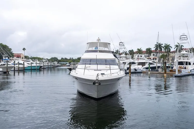 Slide: The Image of 2000 Sea Ray 560 Sedan Bridge yacht docked in a marina with other boats. - 8