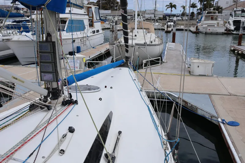 Slide: The Image of Sailboat docked at marina, Sydney 38 model, 2000, surrounded by other boats. - 12