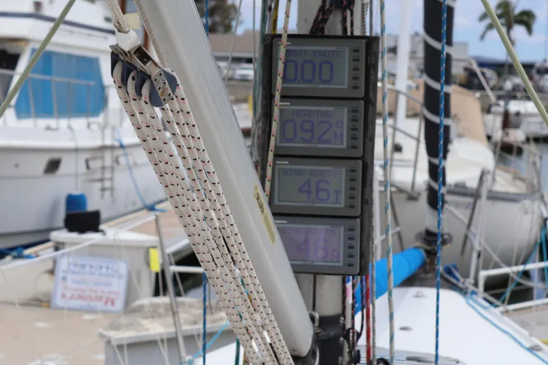 Slide: The Image of Sailing instruments on a 2000 Sydney 38 yacht, displaying speed and wind data at a marina. - 13