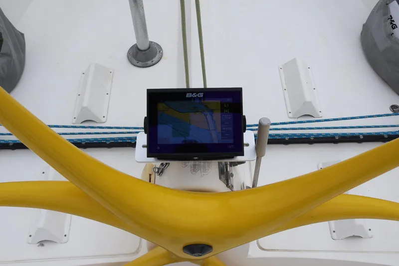 Slide: The Image of Yellow steering wheel and navigation display on a 2000 Sydney 38 sailboat deck. - 14