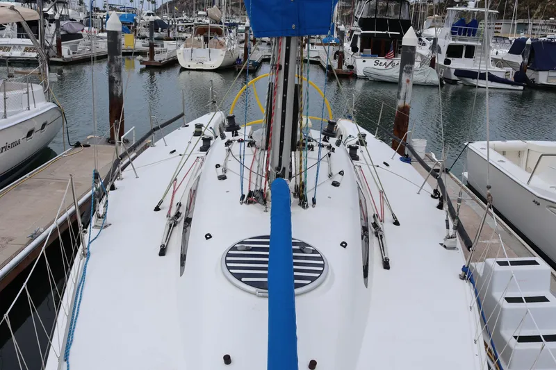 Slide: The Image of Sydney 38 sailboat from 2000 docked in a marina, surrounded by other boats. - 18