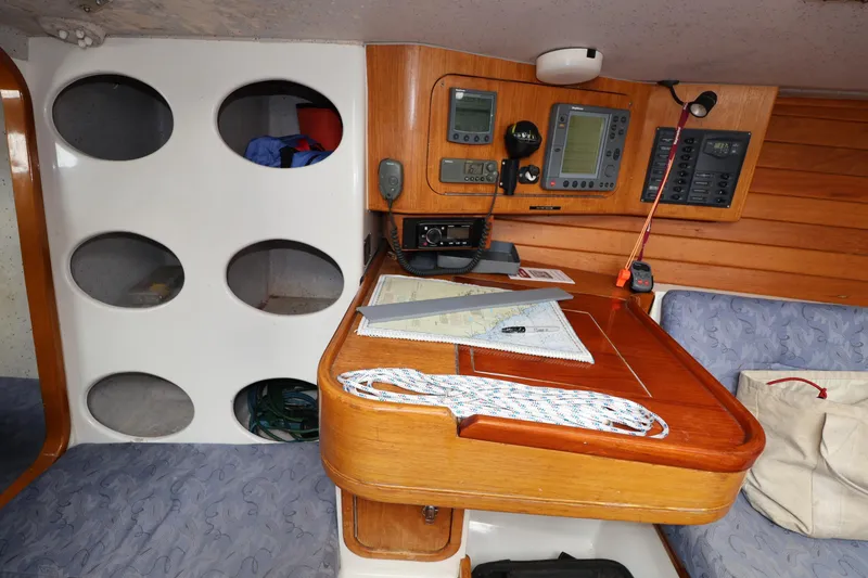 Slide: The Image of Navigation station on a 2000 Sydney 38 yacht with instruments and charts. - 24
