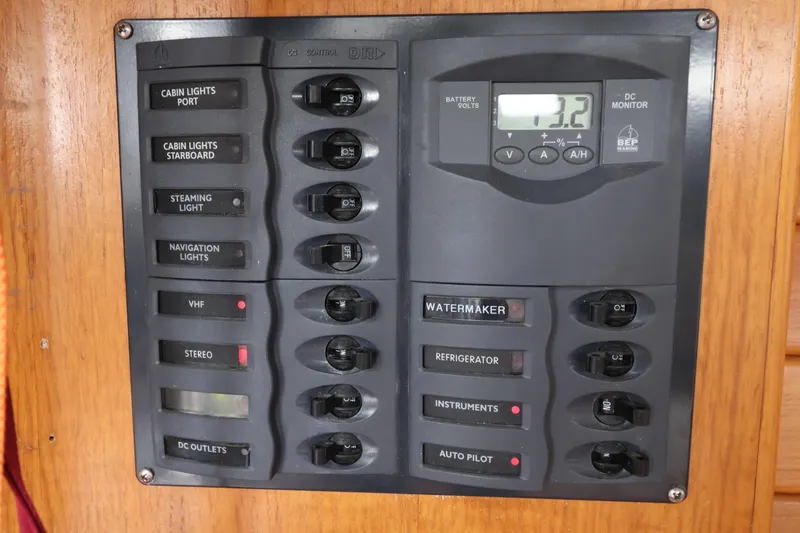 Slide: The Image of Electrical control panel on a 2000 Sydney 38 yacht, featuring switches and a DC monitor. - 26