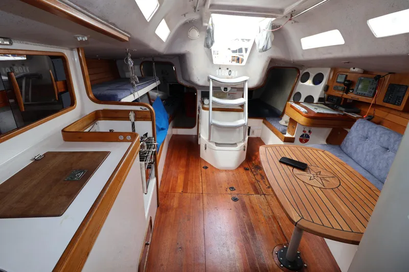 Slide: The Image of Interior of a 2000 Sydney 38 sailboat with wooden flooring and cozy seating. - 27