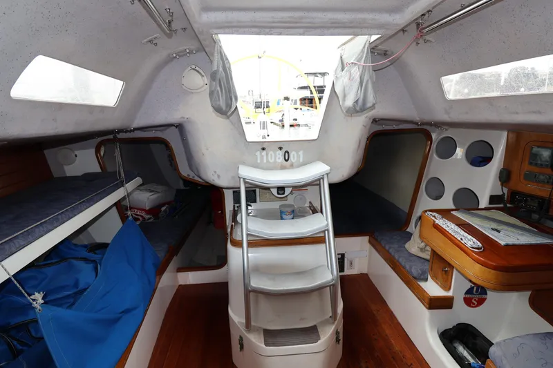Slide: The Image of Interior of a 2000 Sydney 38 sailboat, featuring cozy bunks and a navigation station. - 30