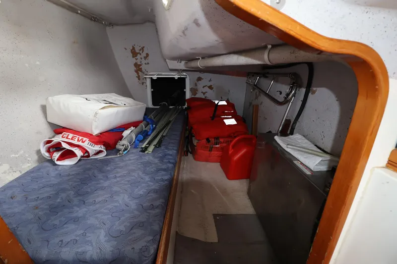 Slide: The Image of Interior of a 2000 Sydney 38 sailboat with storage and safety equipment. - 32
