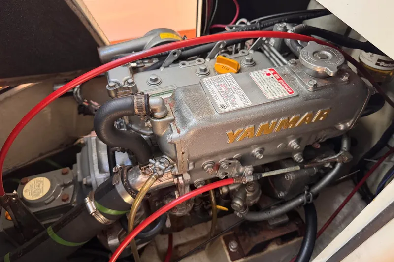 Slide: The Image of Yanmar engine in a 2000 Sydney 38 sailboat, featuring red and black hoses. - 37