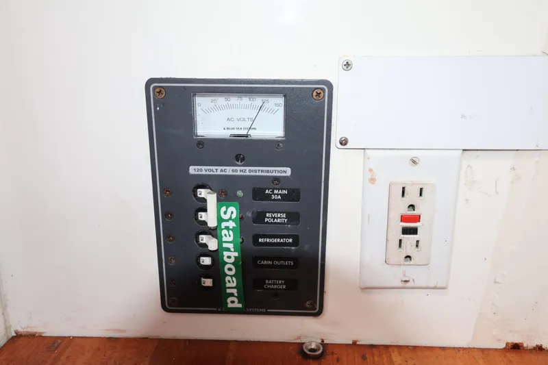 Slide: The Image of Electrical panel with AC voltmeter and outlet on a Sydney 38, year 2000. - 39