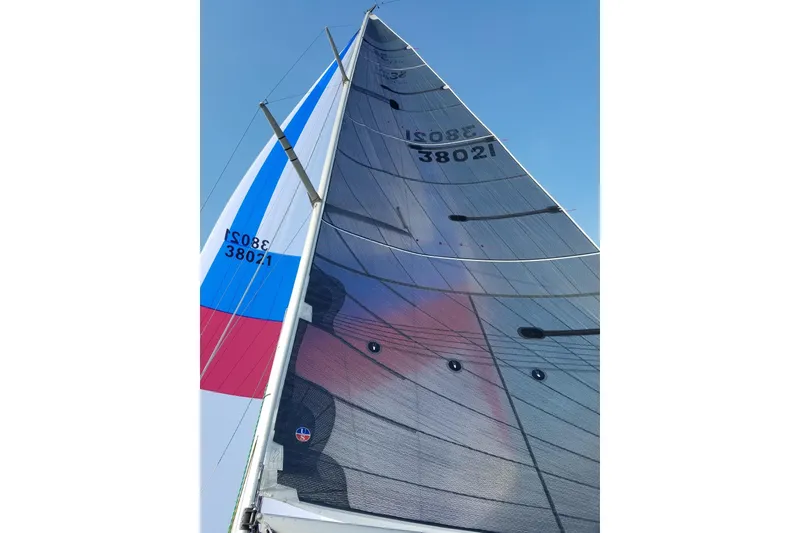 Slide: The Image of Sailboat with colorful sails against blue sky, Sydney 38 model, year 2000. - 4