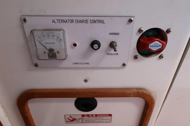Slide: The Image of Alternator charge control panel with Lewco ammeter and regulator switch on Sydney 38, 2000 model. - 41
