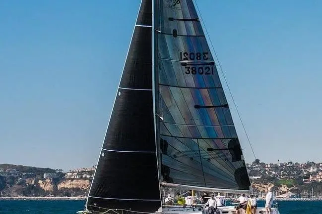 Slide: The Image of Sailing yacht Sydney 38 from 2000 gliding on the ocean with crew onboard. - 5