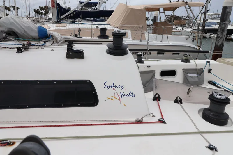 Slide: The Image of Sydney 38 yacht from 2000 docked at a marina with visible rigging. - 6