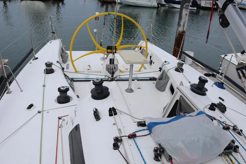 Slide: The Image of Cockpit of a 2000 Sydney 38 sailboat with yellow steering wheel and winches. - 8