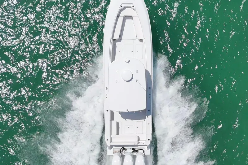 Slide: The Image of Aerial view of 2013 Contender 35 LS boat cruising on turquoise water. - 10