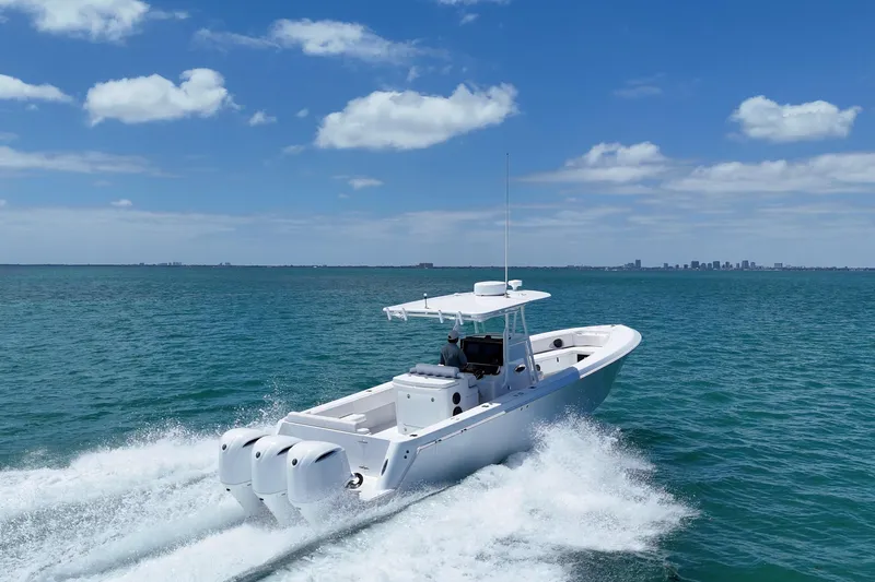 Slide: The Image of Contender 35 LS 2013 boat cruising on open water under a clear blue sky. - 11