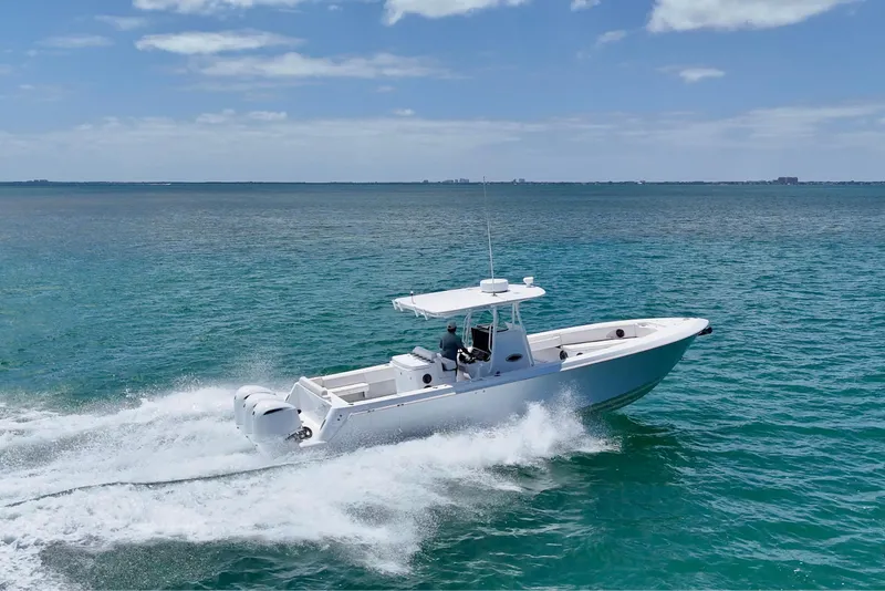 Slide: The Image of 2013 Contender 35 LS boat cruising on clear blue ocean waters. - 12