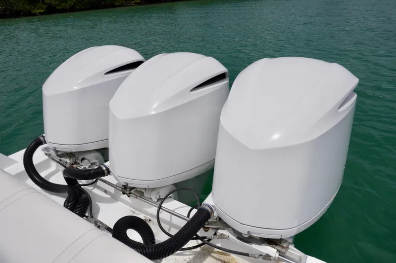 Slide: The Image of Triple outboard motors on a 2013 Contender 35 LS boat in clear water. - 13