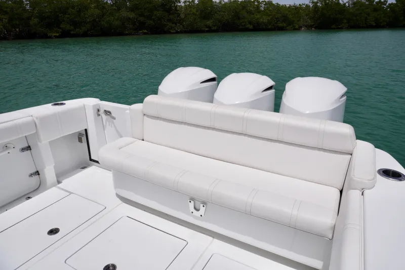Slide: The Image of 2013 Contender 35 LS boat with triple engines and white seating on calm water. - 14