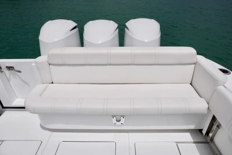 Slide: The Image of Contender 35 LS 2013 boat with white seating and triple outboard motors. - 15