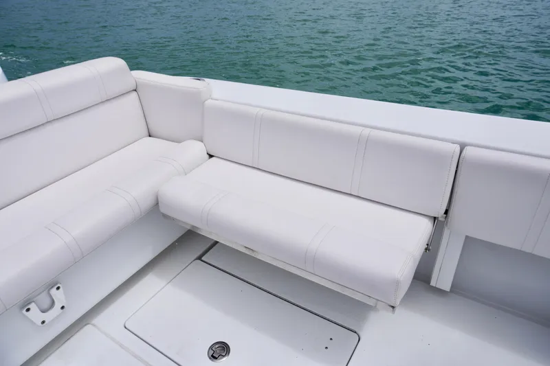 Slide: The Image of White seating on 2013 Contender 35 LS boat, overlooking calm water. - 17