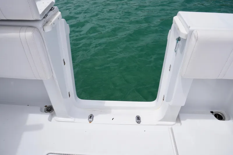 Slide: The Image of Contender 35 LS 2013 boat with open transom door, overlooking green water. - 18