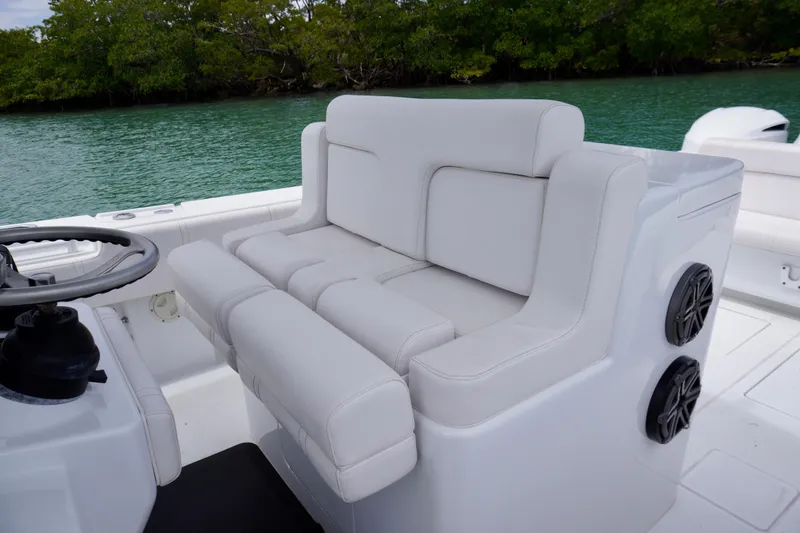 Slide: The Image of Contender 35 LS 2013 boat interior with white cushioned seating and steering wheel. - 21