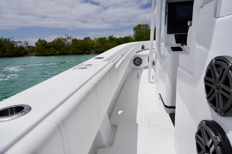 Slide: The Image of 2013 Contender 35 LS boat interior with sleek white design and modern speakers. - 24
