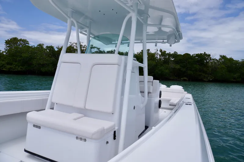 Slide: The Image of 2013 Contender 35 LS boat with sleek white seating, cruising on calm waters. - 29