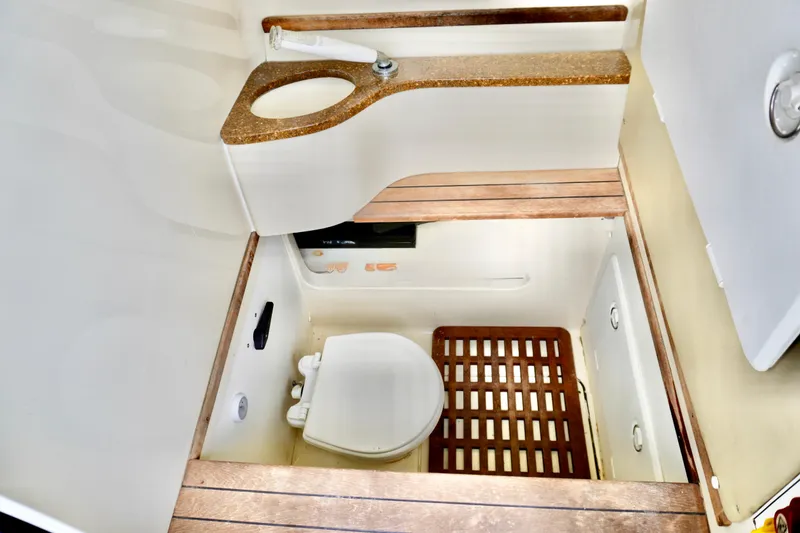 Slide: The Image of 2013 Contender 35 LS boat bathroom with wooden flooring and compact design. - 30