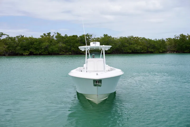 Slide: The Image of 2013 Contender 35 LS boat on calm water with lush green shoreline. - 6