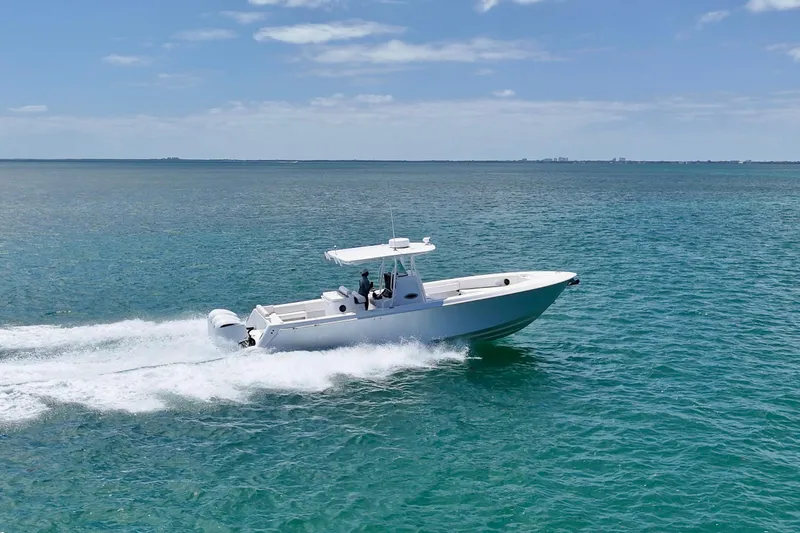 Slide: The Image of 2013 Contender 35 LS boat cruising on open water under clear skies. - 8