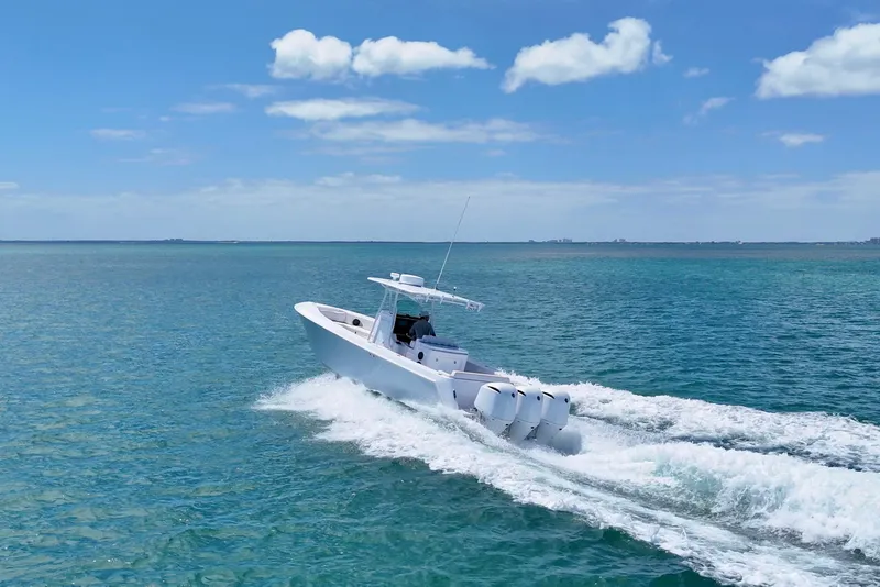 Slide: The Image of 2013 Contender 35 LS boat cruising on clear blue ocean under a sunny sky. - 9