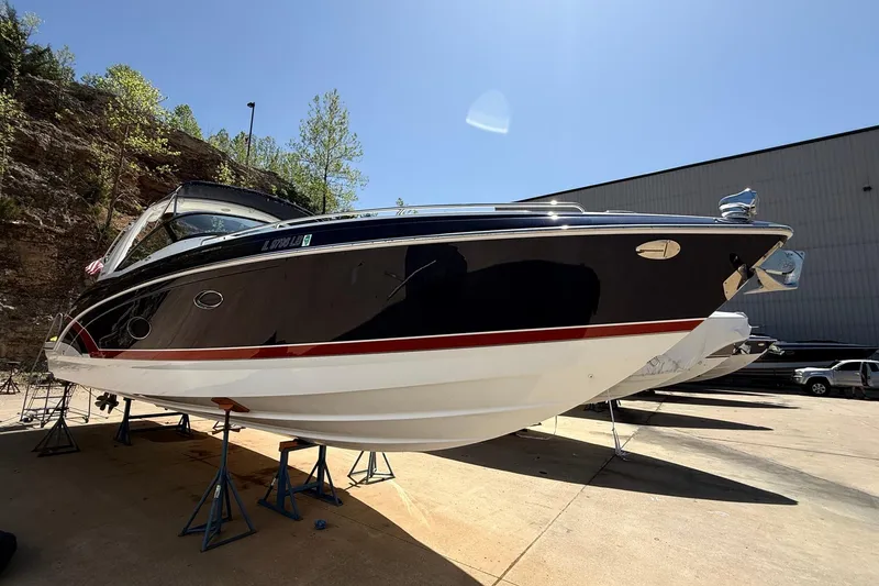 The Image of 2015 Formula 350 Crossover Bowrider on stands, outdoor setting, sunny day. - 0