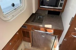 Slide: The Image of 2015 Formula 350 Crossover Bowrider bathroom with modern amenities and compact design. - 27