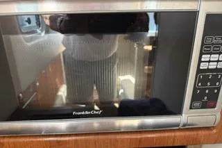 Slide: The Image of 2015 Formula 350 Crossover Bowrider bathroom with compact toilet and wooden cabinetry. - 28