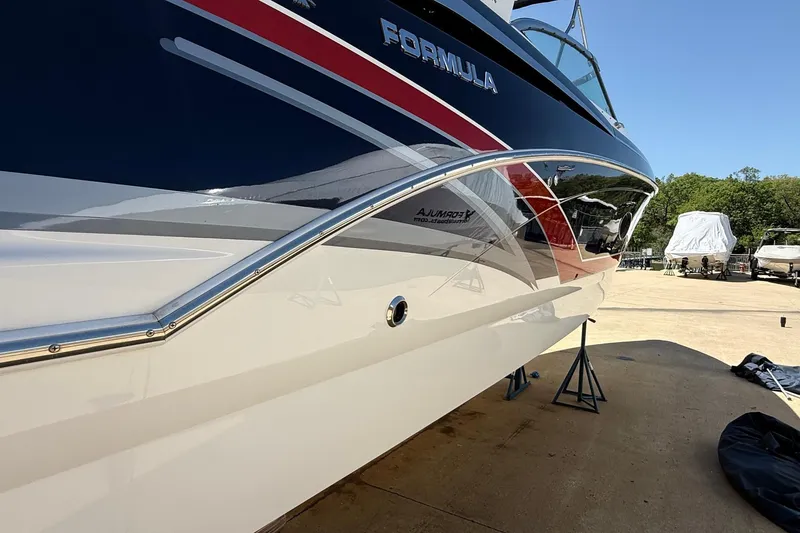 Slide: The Image of 2015 Formula 350 Crossover Bowrider with sleek design on display outdoors. - 3