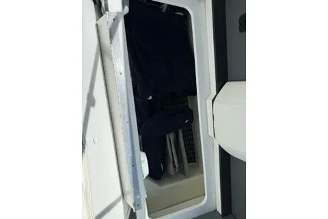 Slide: The Image of 2015 Formula 350 Crossover Bowrider with American flag, docked on a sunny day. - 34