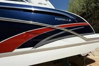 Slide: The Image of 2015 Formula 350 Crossover Bowrider boat with sleek design and vibrant colors. - 4