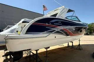 Slide: The Image of 2015 Formula 350 Crossover Bowrider with sleek navy and red hull design. - 42