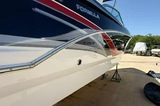 Slide: The Image of 2015 Formula 350 Crossover Bowrider boat with sleek design and vibrant colors. - 43