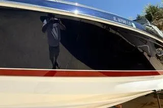 Slide: The Image of 2015 Formula 350 Crossover Bowrider boat on display under clear blue sky. - 45